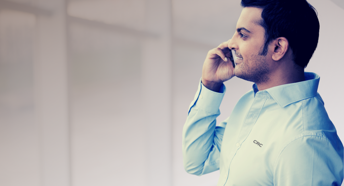 man talking on phone looking out window